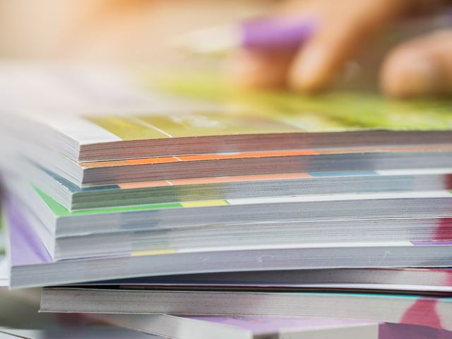 A stack of freshly printed booklets and magazines