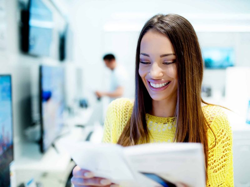 Student reading a freshly printed course booklet